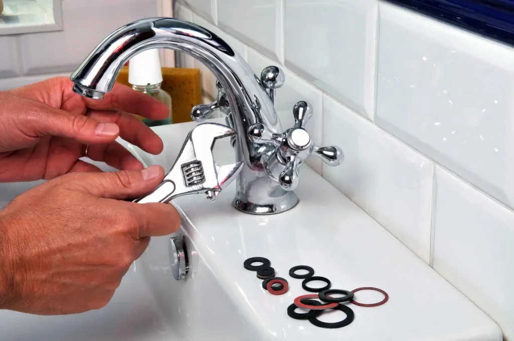 Plumber performing maintenance on a bathroom faucet in Hollywood