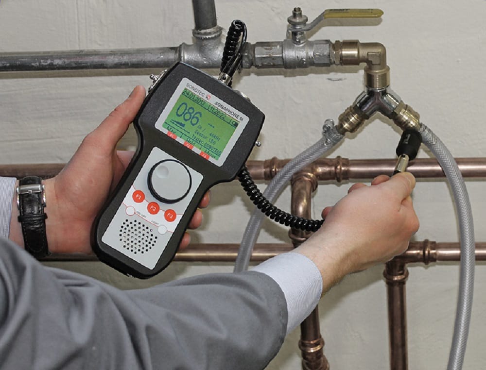 Plumber testing pipes with electronic leak detection equipment in Hollywood