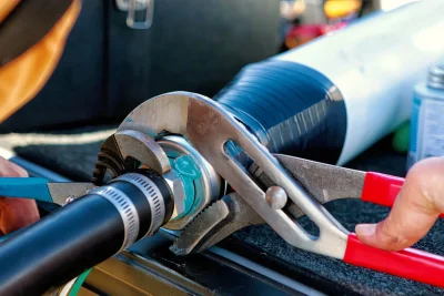 Technician tightening an industrial pipe connection in Hollywood
