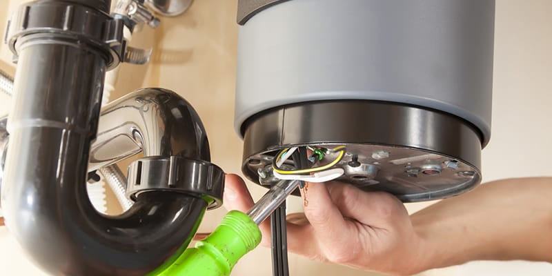Technician repairing the heating element of a water heater in Hollywood