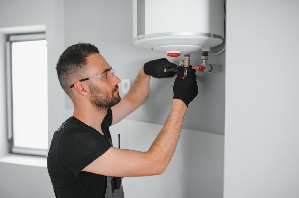 Technician performing water heater maintenance in Hollywood